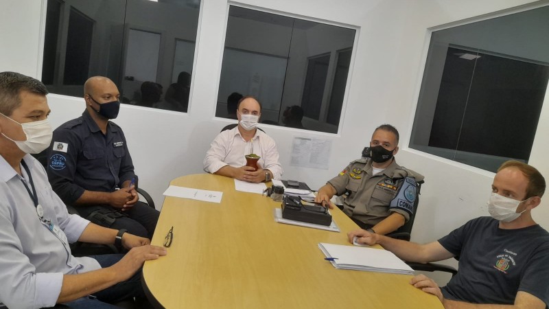 Em uma mesa esta presente o tenente-coronel Moresco, Comandante do CRPO/VRP, ao lado do Coronel Reis, secretario de segurança pública do município, juntamente com três servidores da secretaria.